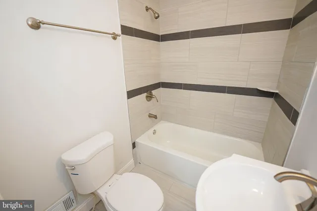 a bathroom with a sink mirror and toilet