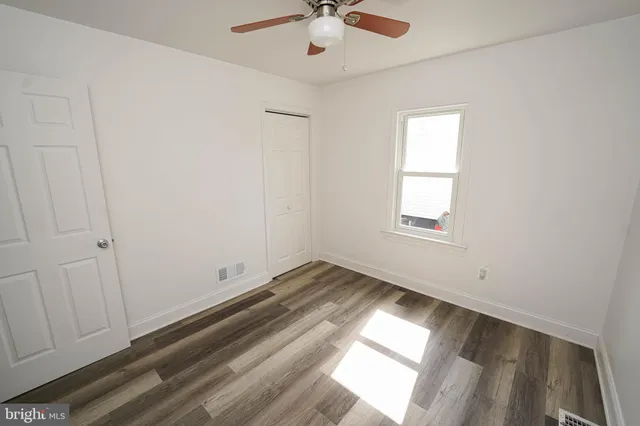 a view of room with window and hardwood floor