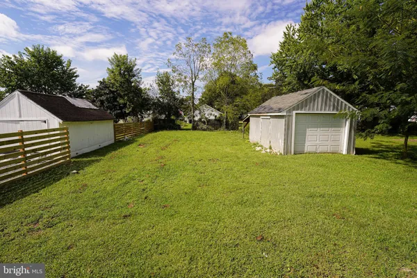 a front view of a house with yard and green space