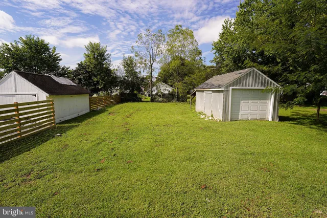 a front view of a house with yard and green space