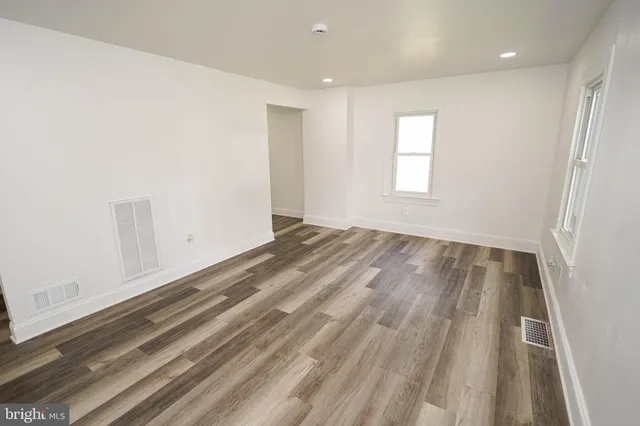 a view of room with window and hardwood floor