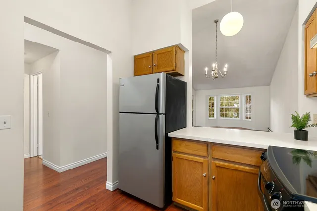 a kitchen with a refrigerator and a sink