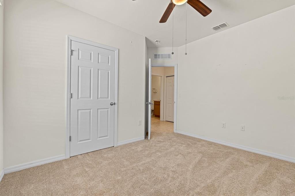 8932 Excelsior Place Venice, FL 34293 - Photo 27 of 43 an empty room with chandelier fan