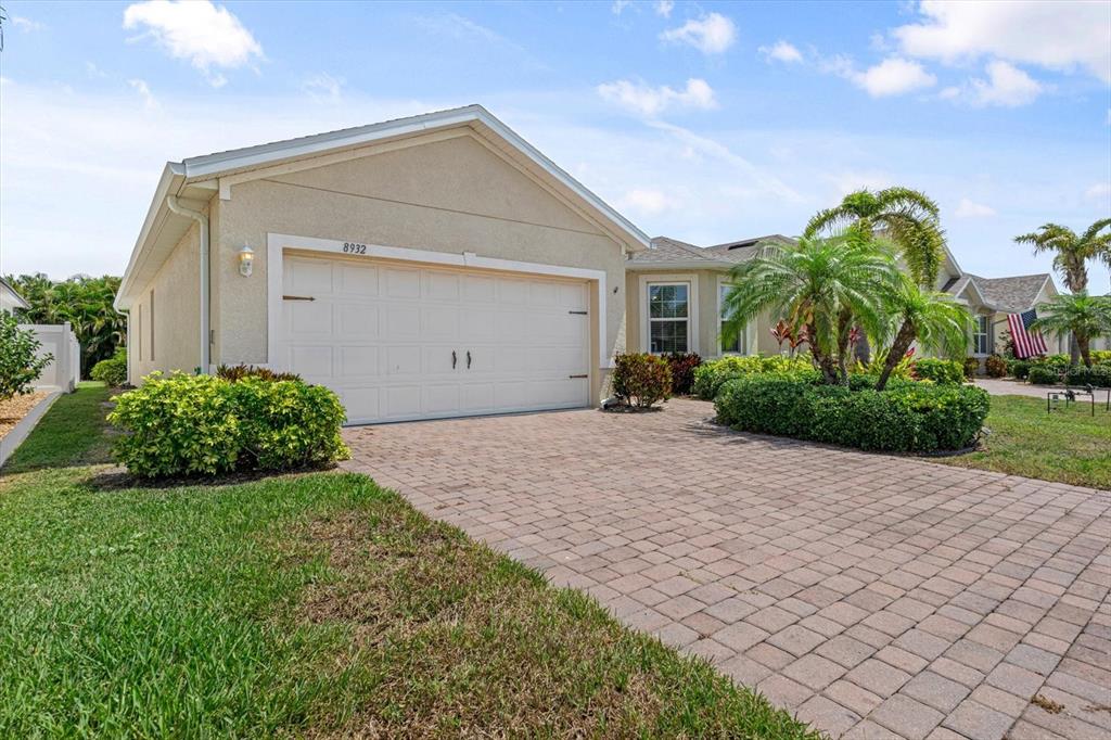 8932 Excelsior Place Venice, FL 34293 - Photo 32 of 43 a view of a house with a yard and potted plants