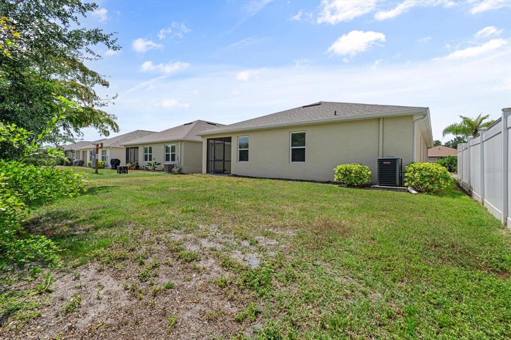 8932 Excelsior Place Venice, FL 34293 - Photo 34 of 43 a view of a house with a yard and potted plants