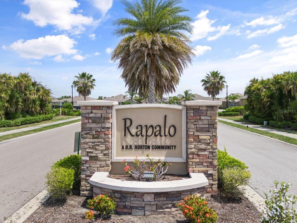 8932 Excelsior Place Venice, FL 34293 - Photo 39 of 43 a sign that is in front of flowers
