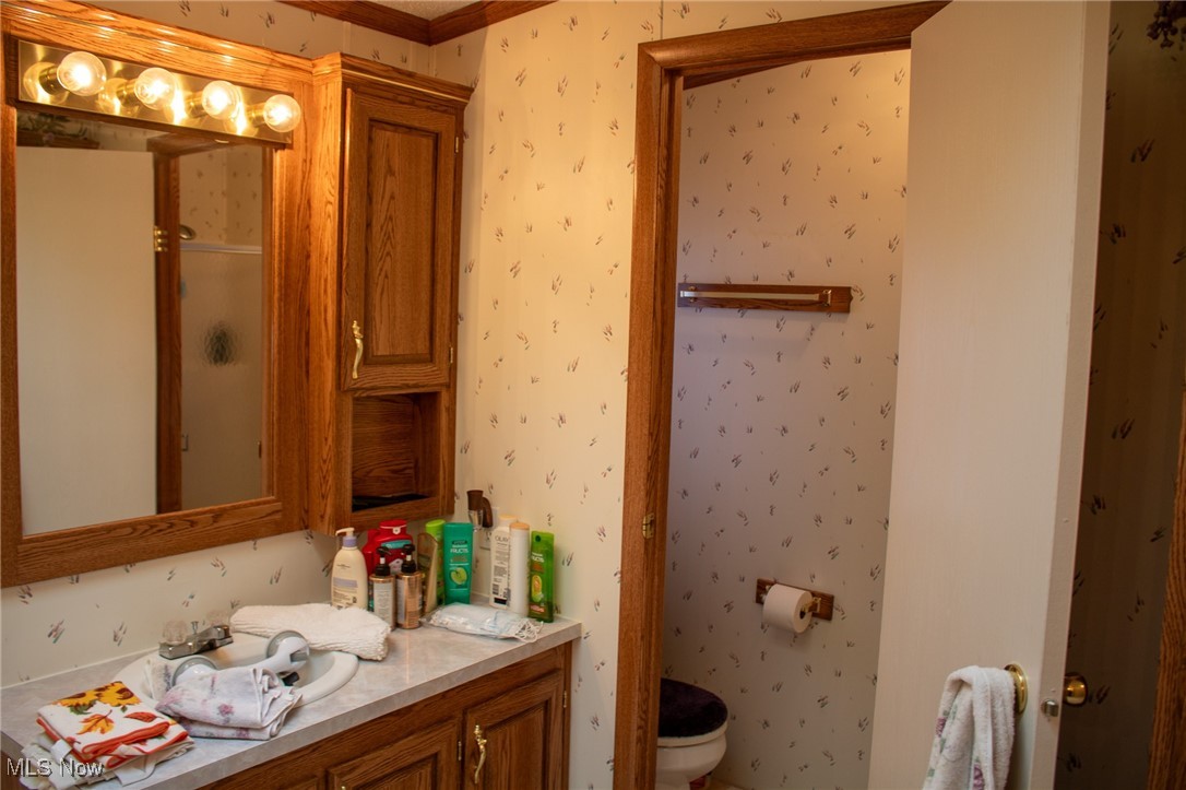 61691 Wintergreen Road Lore City, OH 43755 - Photo 19 of 50 Full bath with wallpapered walls, vanity, and an enclosed shower