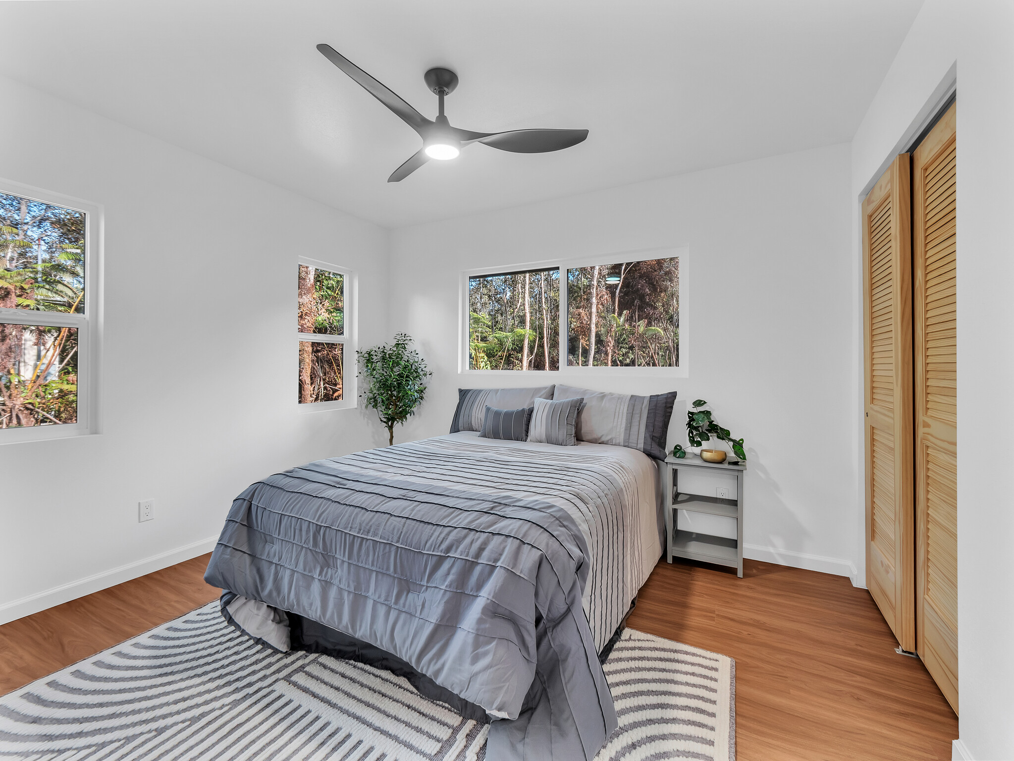 11-3790 9th Street Volcano, HI 96785 - Photo 15 of 30 a bedroom with a bed and wooden floor