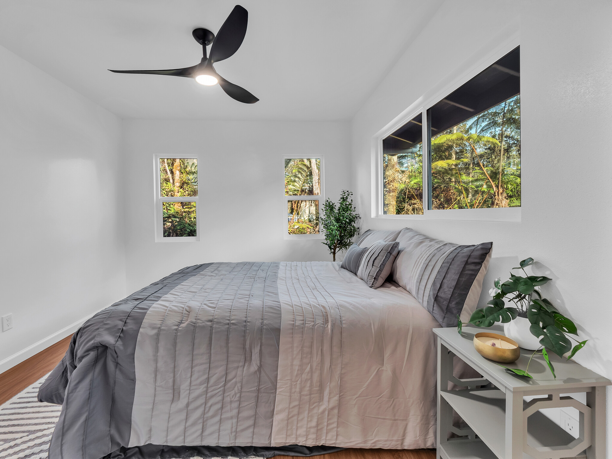 11-3790 9th Street Volcano, HI 96785 - Photo 16 of 30 a bedroom with a bed and a chandelier