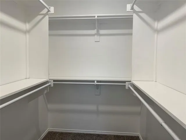 a view of a closet with wooden floor