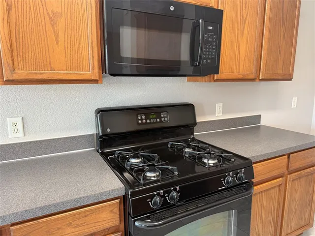 a kitchen with a stove and a microwave