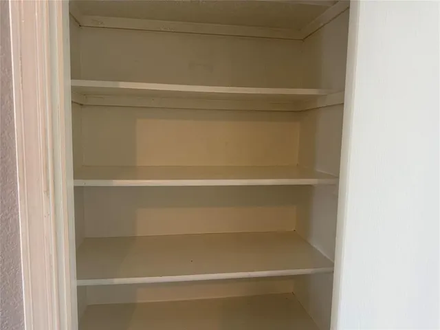 a view of an empty room with empty shelves