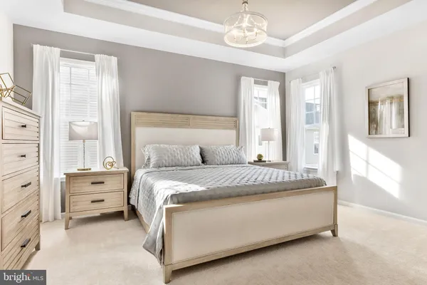 a spacious bedroom with a bed and a window