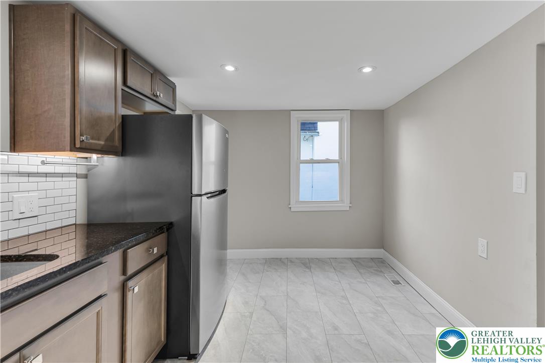 2246 2nd Street Wilson, PA 18042 - Photo 11 of 47 a kitchen with stainless steel appliances granite countertop a refrigerator and a stove