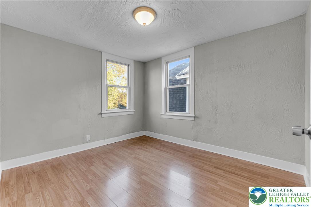 2246 2nd Street Wilson, PA 18042 - Photo 18 of 47 an empty room with wooden floor and windows