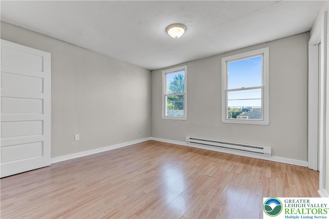 2246 2nd Street Wilson, PA 18042 - Photo 20 of 47 an empty room with wooden floor and windows