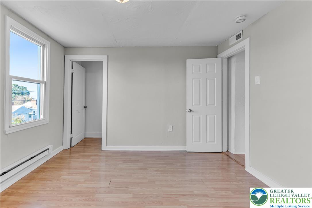 2246 2nd Street Wilson, PA 18042 - Photo 21 of 47 a view of an empty room with wooden floor and a window