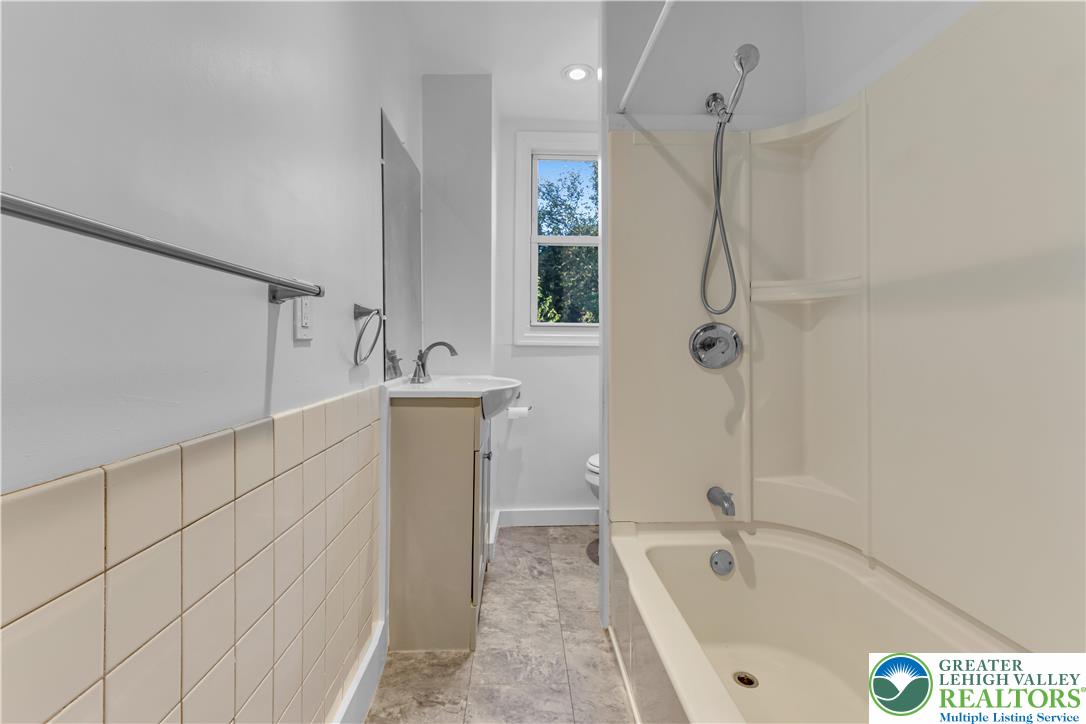 2246 2nd Street Wilson, PA 18042 - Photo 24 of 47 a bathroom with a tub a sink a vanity and a shower