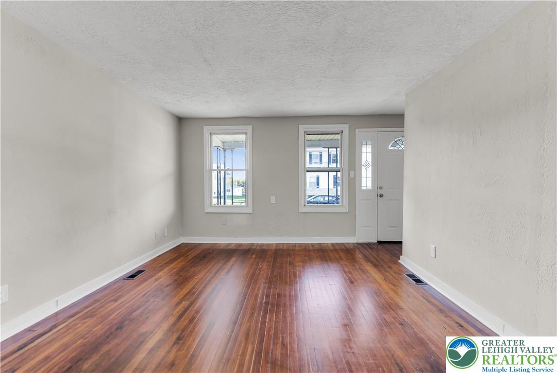 2246 2nd Street Wilson, PA 18042 - Photo 4 of 47 an empty room with wooden floor and windows