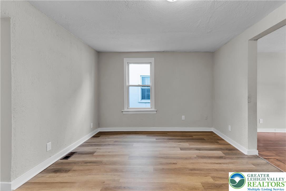 2246 2nd Street Wilson, PA 18042 - Photo 6 of 47 a view of an empty room with wooden floor and a window