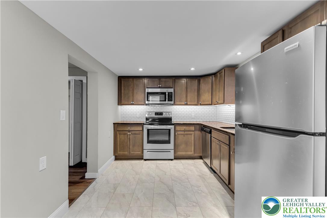2246 2nd Street Wilson, PA 18042 - Photo 10 of 47 a kitchen with stainless steel appliances granite countertop a refrigerator sink and stove