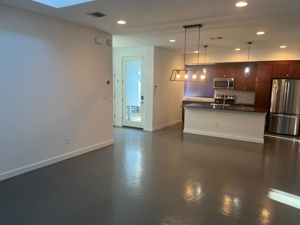 1105 Altum Street Austin, TX 78721 - Photo 3 of 16 a view of a kitchen with a sink and a refrigerator