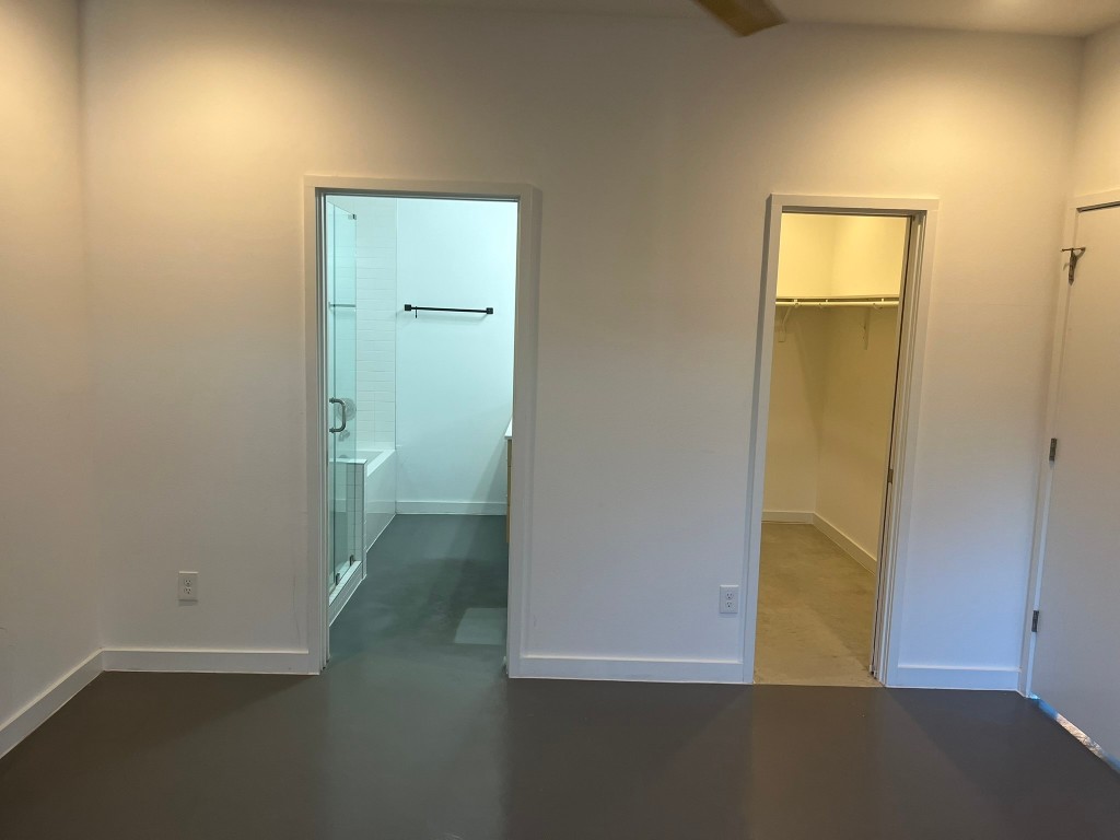 1105 Altum Street Austin, TX 78721 - Photo 7 of 16 an empty room with wooden floor and a bathroom