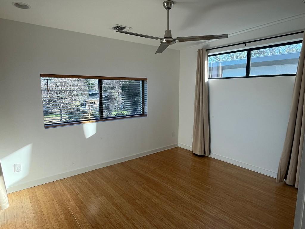 1105 Altum Street Austin, TX 78721 - Photo 8 of 16 a view of an empty room with wooden floor and a window