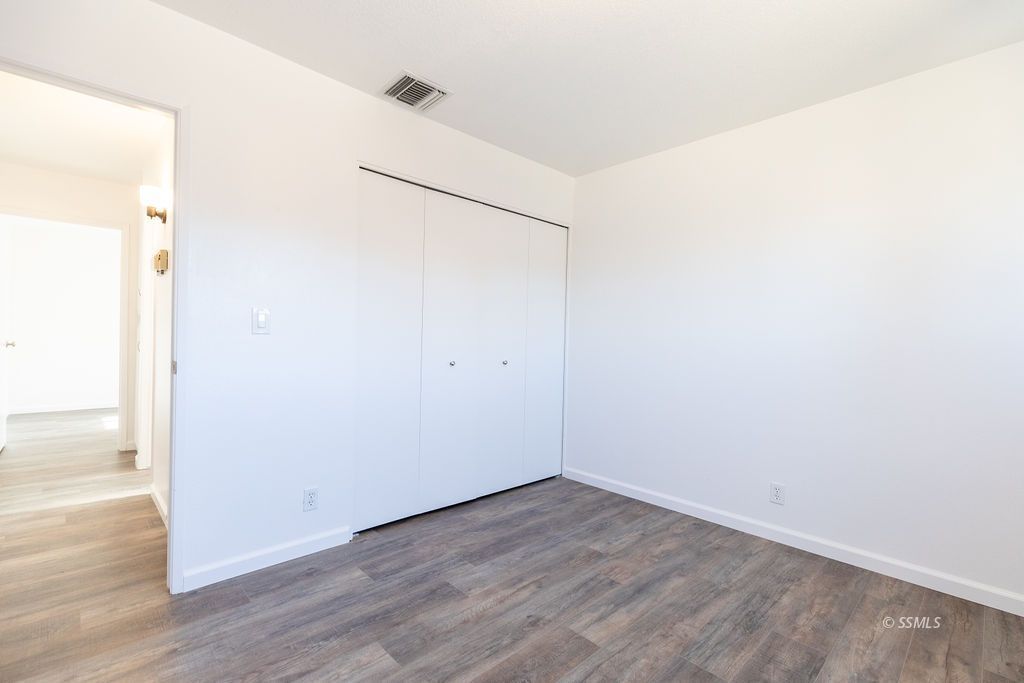 725 Randall Street Ridgecrest, CA 93555 - Photo 22 of 36 an empty room with wooden floor
