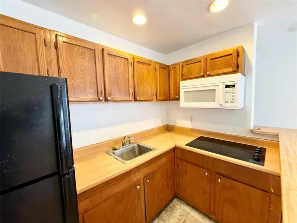 a kitchen with a refrigerator and a sink