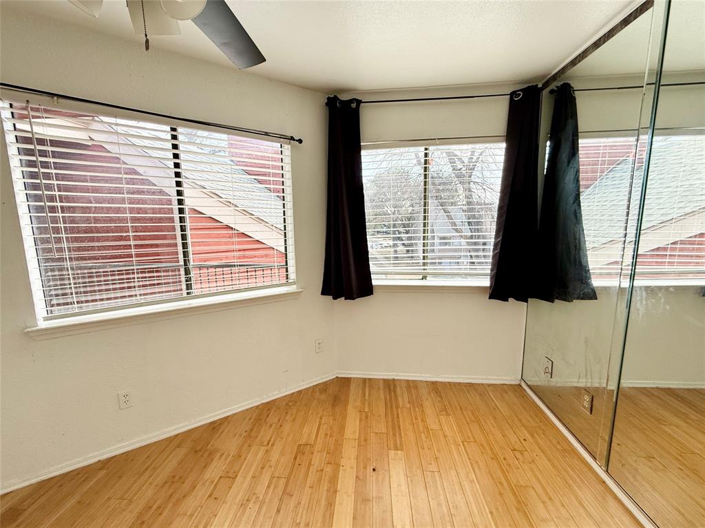 9839 Walnut Street, Unit 305 Dallas, TX 75243 - Photo 6 of 7 a view of a room with wooden floor and windows