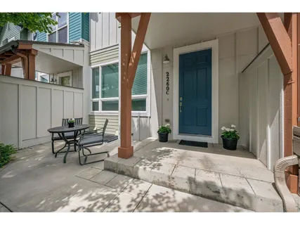 a backyard of a house with table and chairs