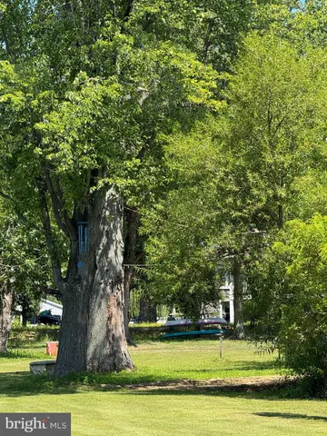 a bathroom with a double vanity sink a mirror and a bathtub