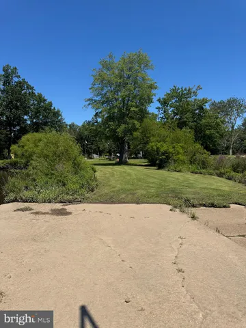 a bedroom with a bed and a large window with the outer view