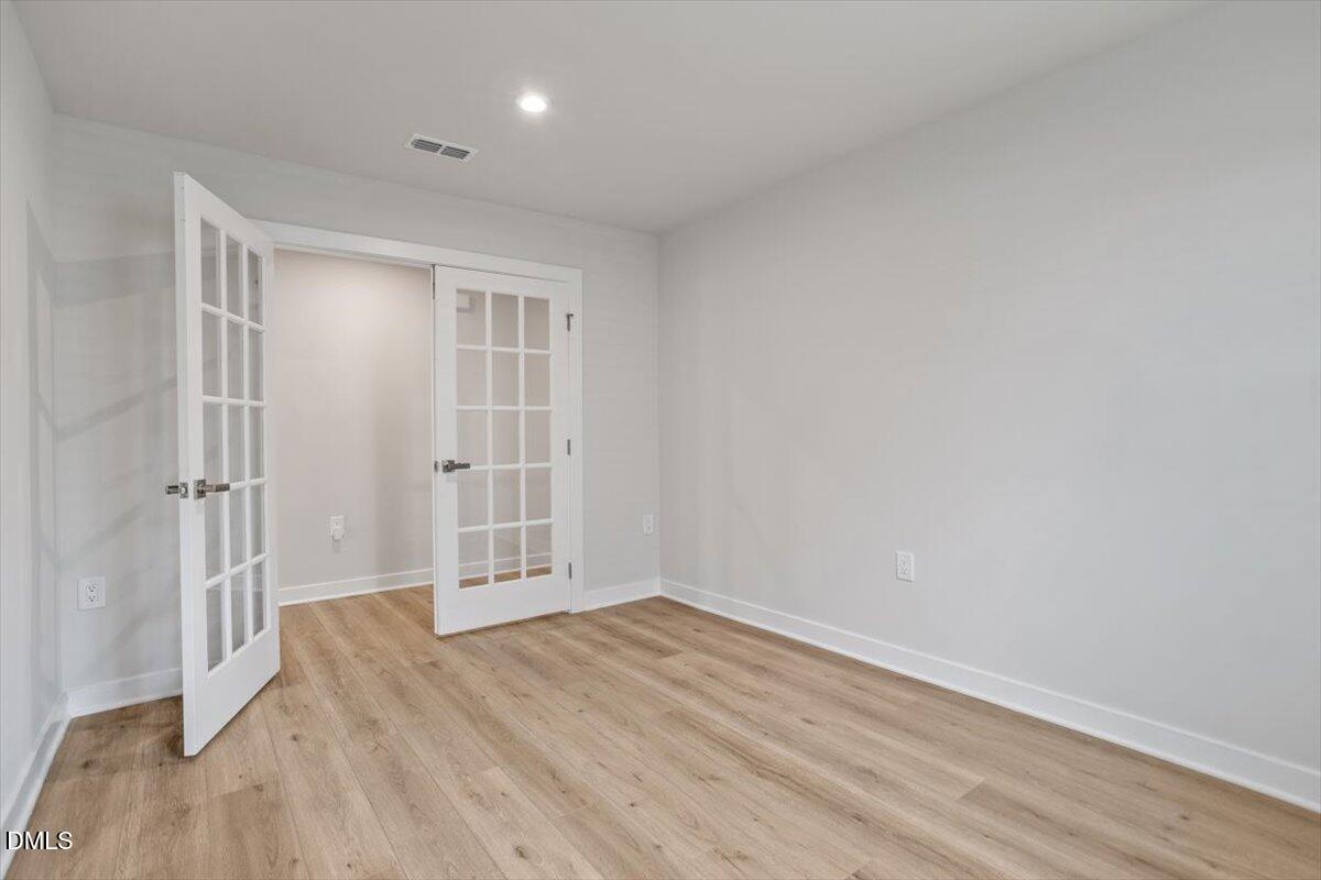 8588 Kenridge Lane Fuquay-Varina, NC 27526 - Photo 11 of 37 a view of wooden floor and windows in a room