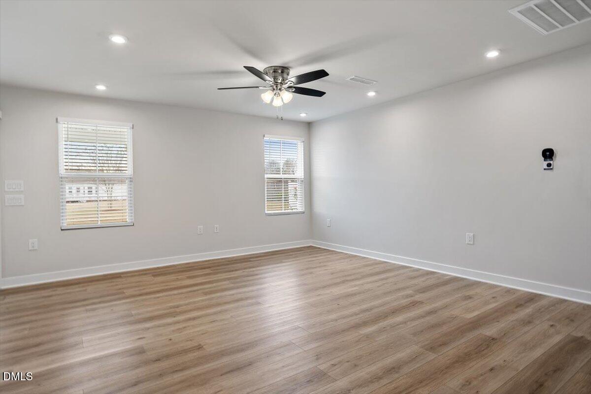 8588 Kenridge Lane Fuquay-Varina, NC 27526 - Photo 18 of 37 a view of an empty room with wooden floor and a window