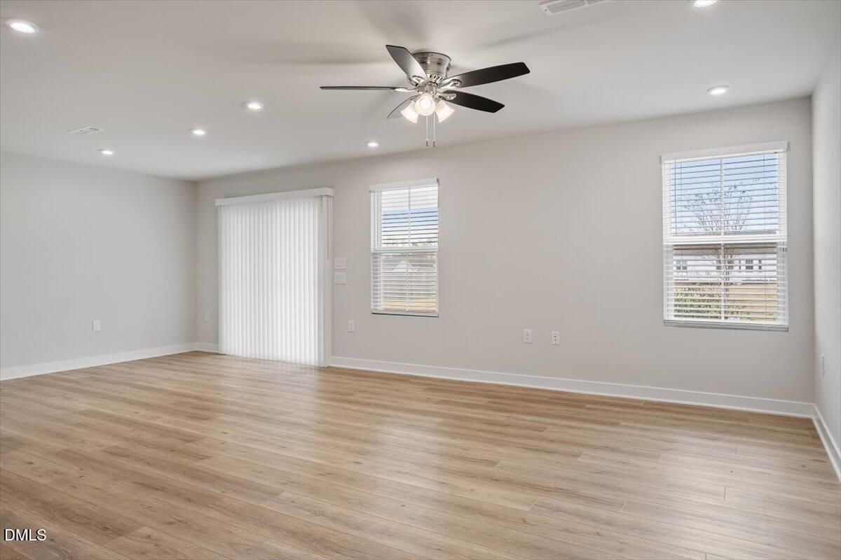 8588 Kenridge Lane Fuquay-Varina, NC 27526 - Photo 19 of 37 a view of an empty room with wooden floor and a window