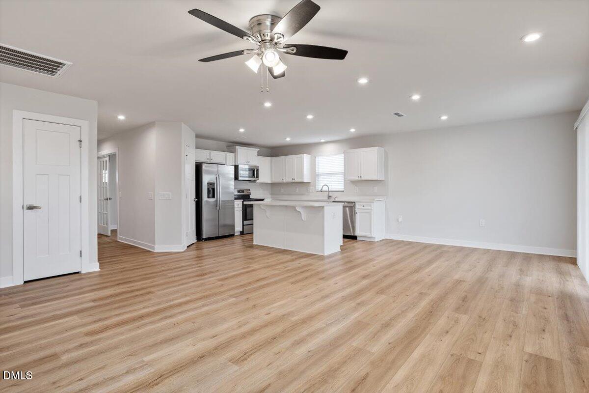 8588 Kenridge Lane Fuquay-Varina, NC 27526 - Photo 21 of 37 a view of a kitchen with a sink and a refrigerator
