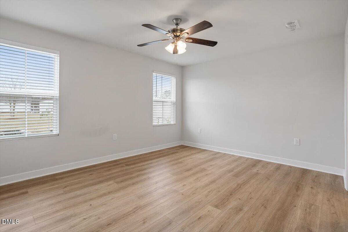 8588 Kenridge Lane Fuquay-Varina, NC 27526 - Photo 24 of 37 an empty room with wooden floor and windows