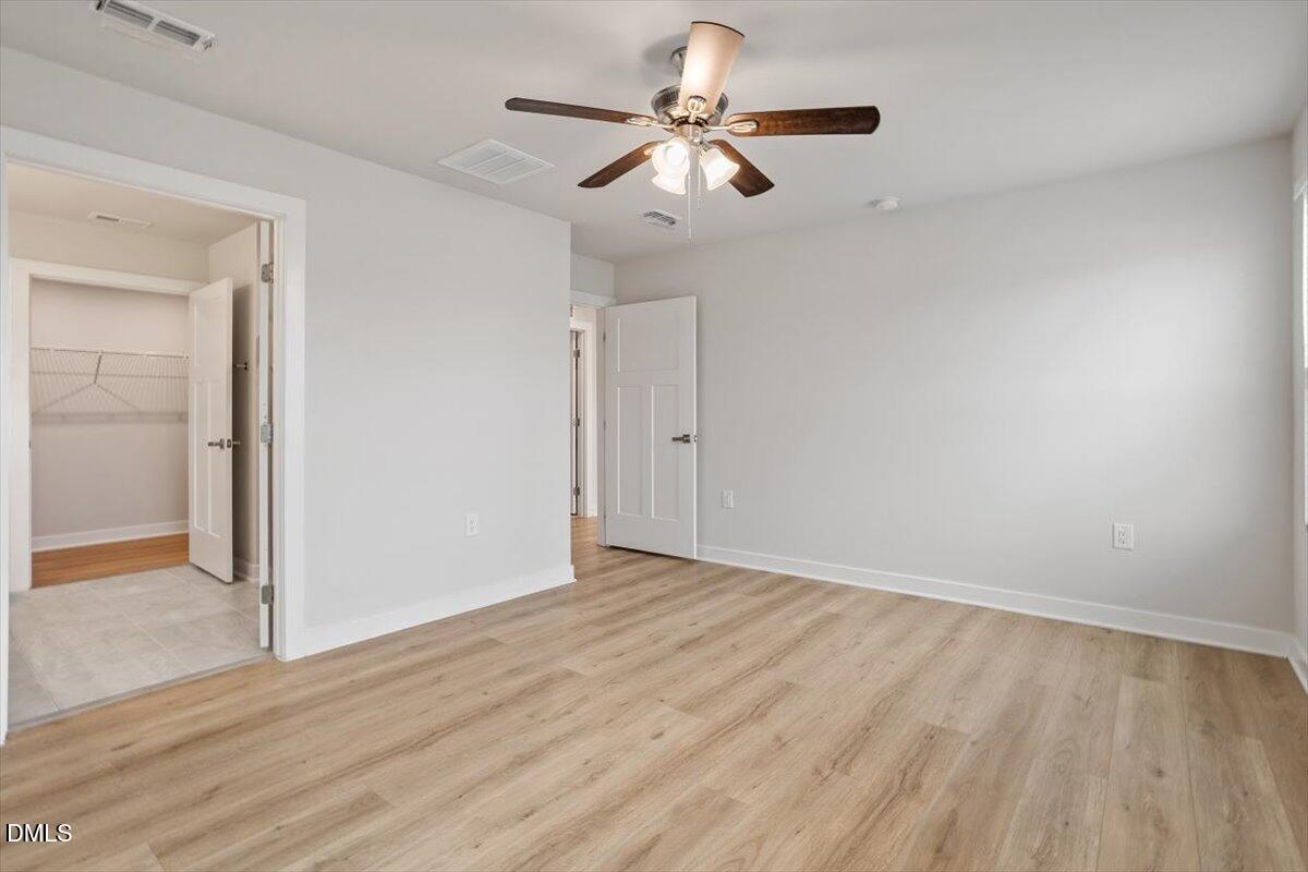 8588 Kenridge Lane Fuquay-Varina, NC 27526 - Photo 25 of 37 a view of an empty room with wooden floor