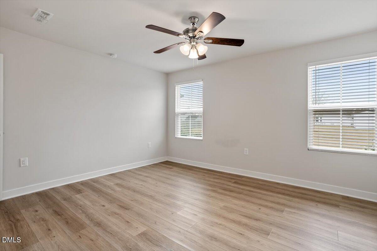 8588 Kenridge Lane Fuquay-Varina, NC 27526 - Photo 26 of 37 a view of an empty room with wooden floor and a window