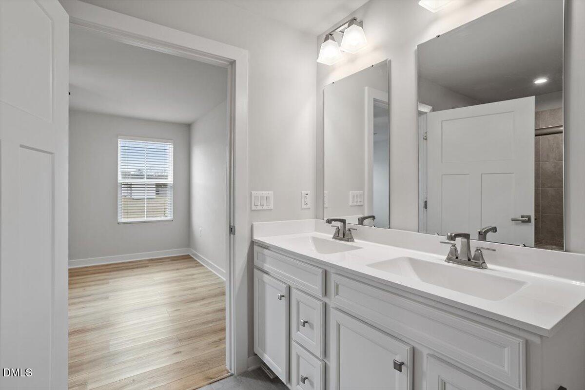 8588 Kenridge Lane Fuquay-Varina, NC 27526 - Photo 29 of 37 a bathroom with 2 sink and a mirror