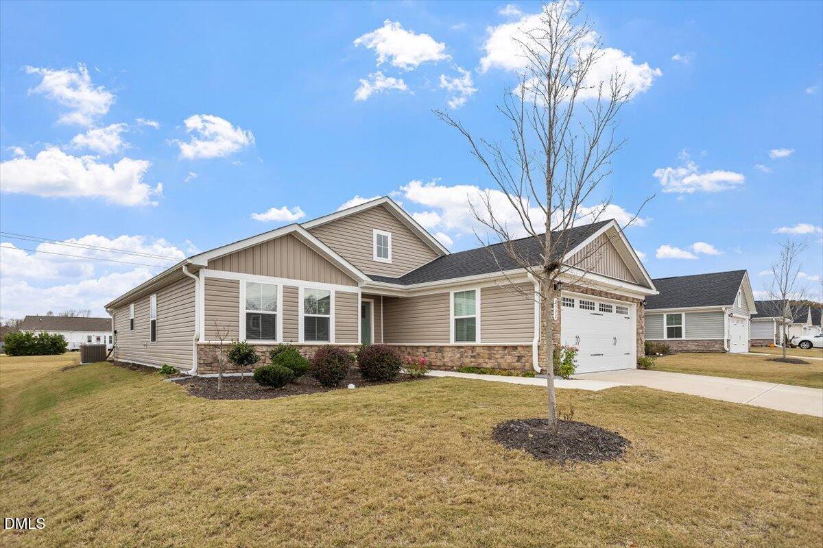 8588 Kenridge Lane Fuquay-Varina, NC 27526 - Photo 2 of 37 a front view of a house with a yard and outdoor seating