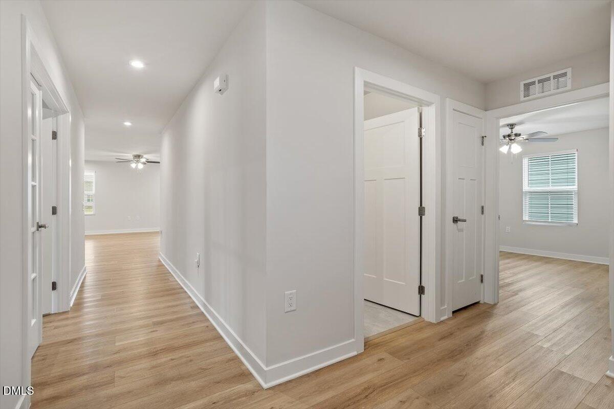 8588 Kenridge Lane Fuquay-Varina, NC 27526 - Photo 5 of 37 a view of a hallway with wooden floor