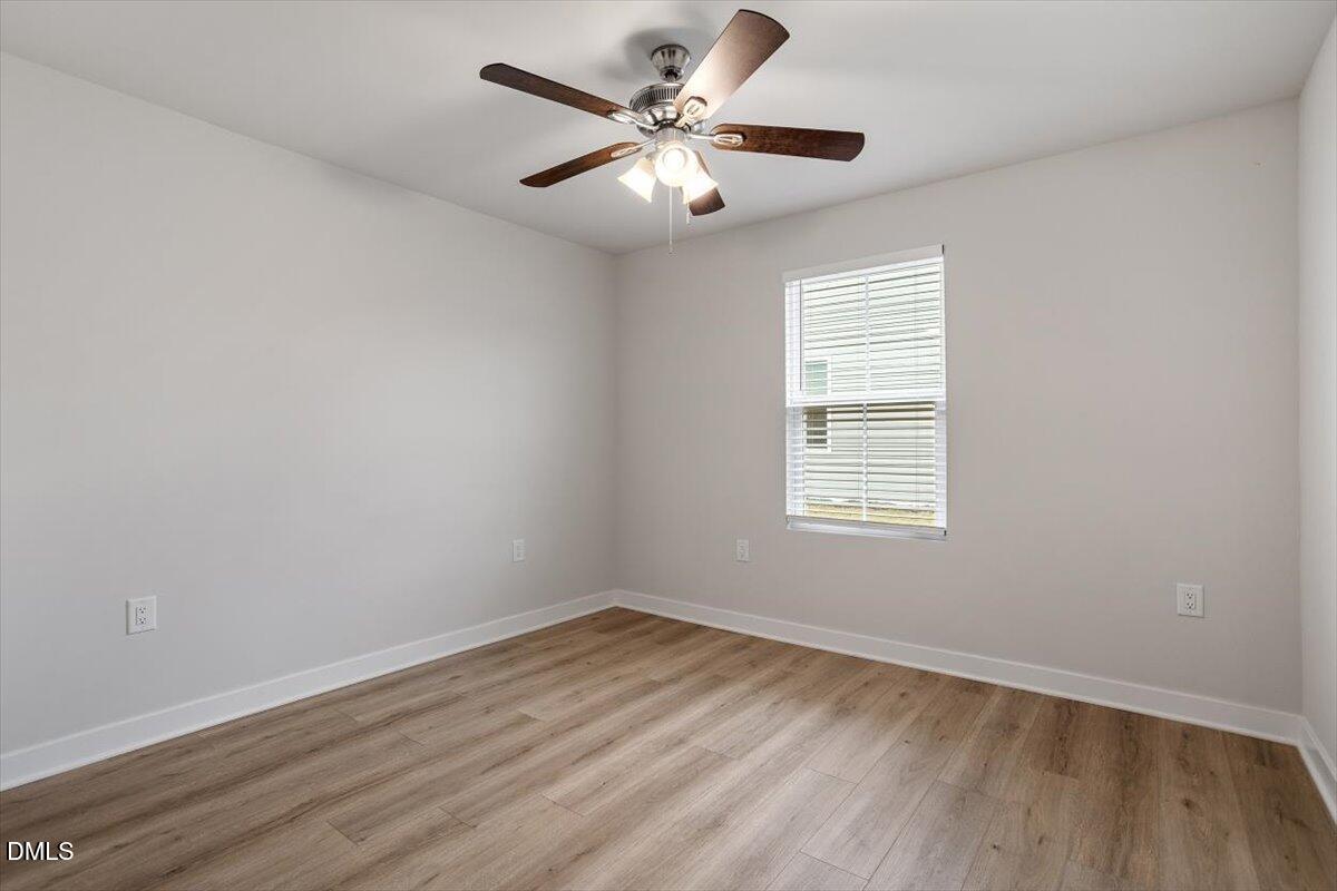 8588 Kenridge Lane Fuquay-Varina, NC 27526 - Photo 7 of 37 wooden floor in an empty room with a window