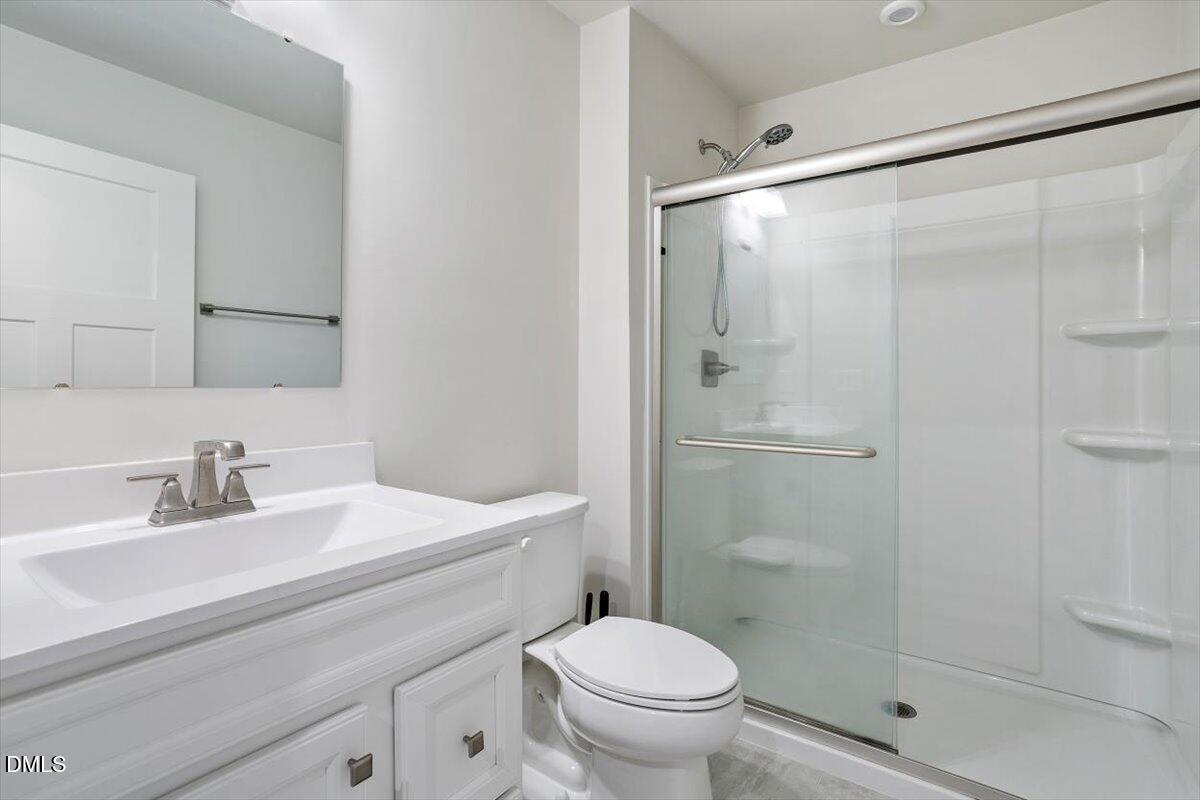 8588 Kenridge Lane Fuquay-Varina, NC 27526 - Photo 8 of 37 a bathroom with a sink toilet and shower