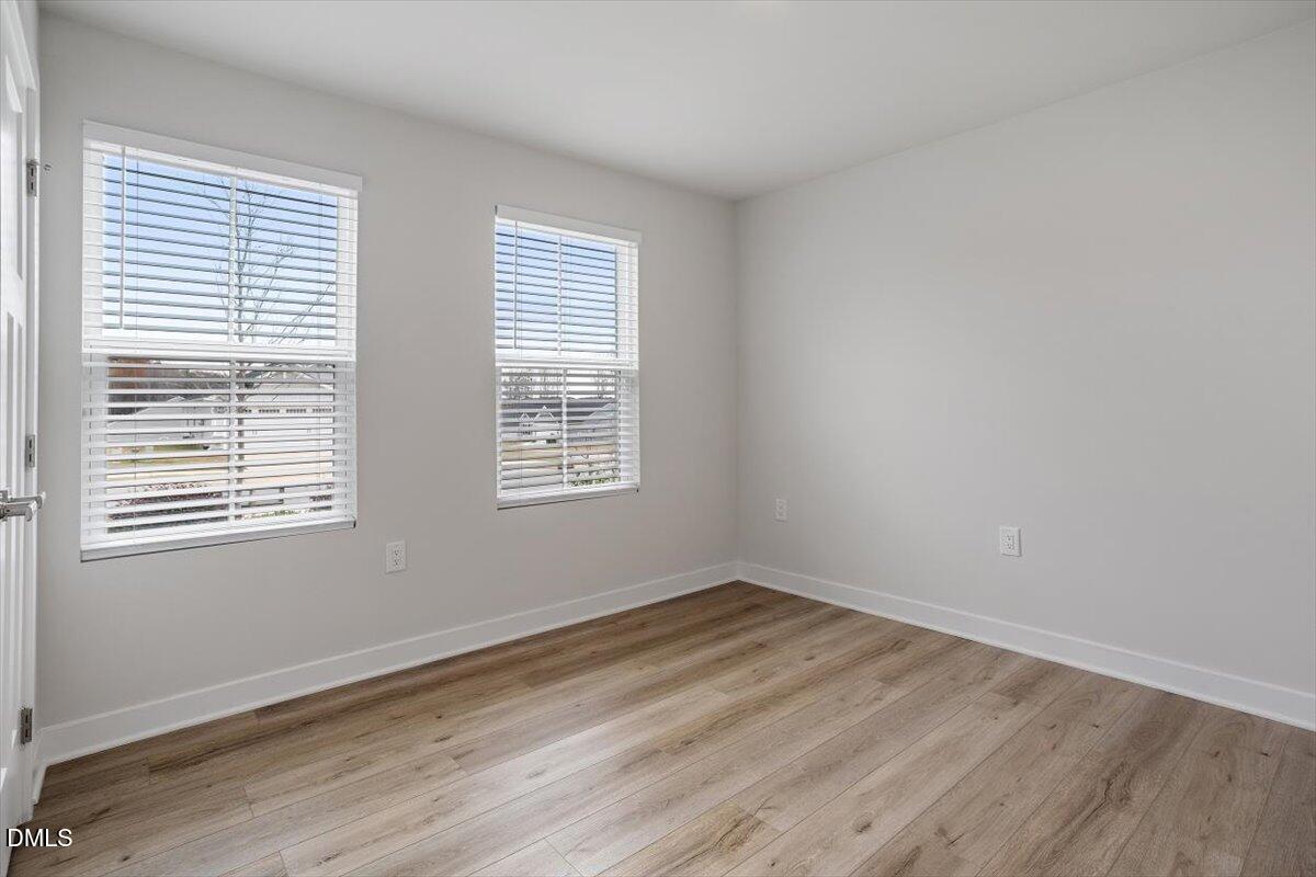 8588 Kenridge Lane Fuquay-Varina, NC 27526 - Photo 9 of 37 a view of a room with wooden floor and windows