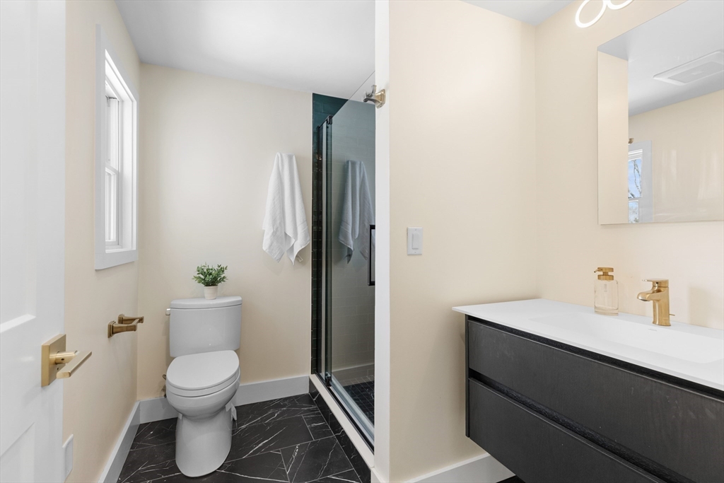 1 Maureen Road Lexington, MA 02420 - Photo 32 of 40 a bathroom with a toilet a sink and tub