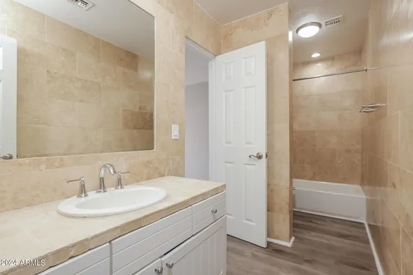a bathroom with a sink and a mirror