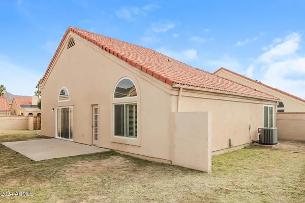 a view of a house with a backyard
